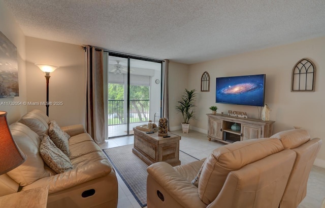 tiled living room featuring floor to ceiling windows and a textured ceiling