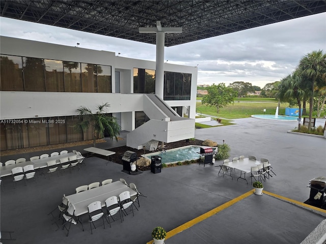 exterior space with an outdoor bar, a swimming pool, and a patio