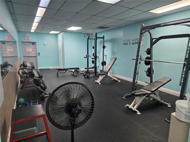 workout area with a paneled ceiling