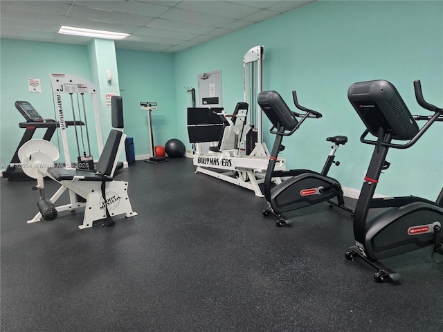 workout area with a paneled ceiling