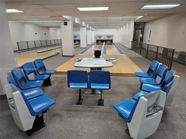 playroom with bowling, carpet floors, and a drop ceiling