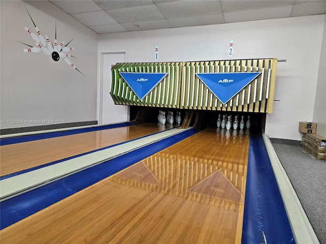 recreation room featuring a bowling alley and a drop ceiling