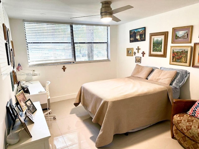 tiled bedroom featuring ceiling fan