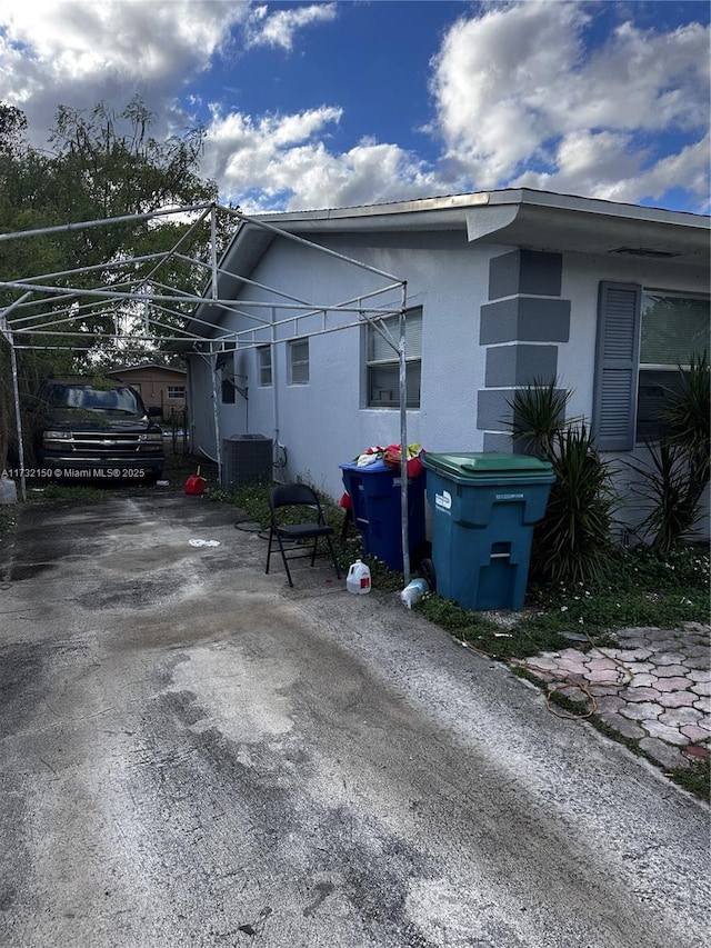 view of property exterior with central AC