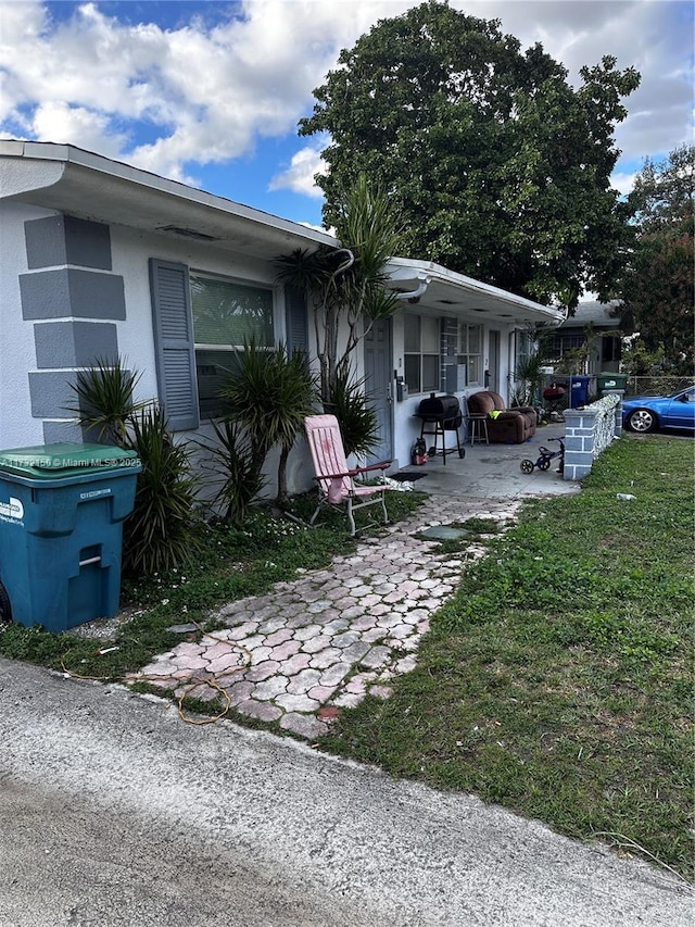 exterior space with a patio area and a lawn