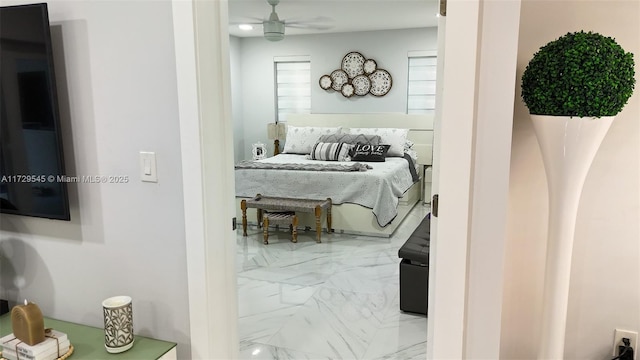 bedroom featuring marble finish floor