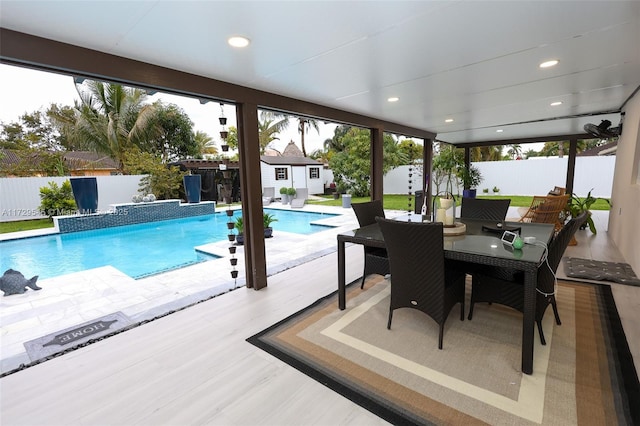 view of pool featuring a fenced backyard, outdoor dining area, a fenced in pool, and an outdoor structure