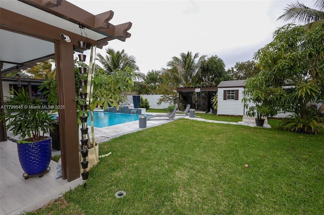 outdoor pool with a storage shed, a lawn, an outdoor structure, and fence