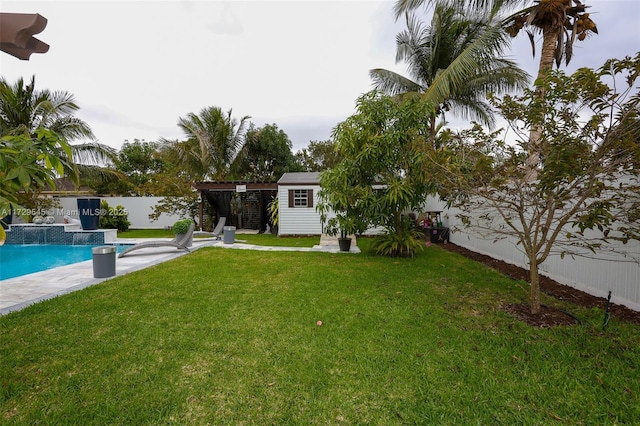 view of yard featuring fence and an outdoor pool