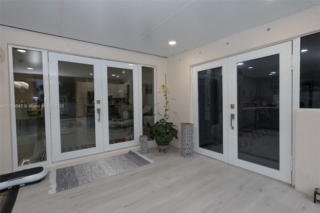 property entrance featuring french doors and stucco siding