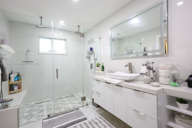 bathroom with a shower stall and vanity