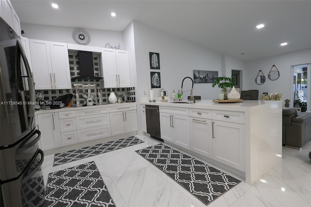 kitchen featuring a peninsula, a sink, vaulted ceiling, wall chimney range hood, and black appliances