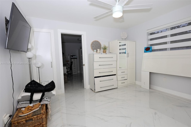 bedroom featuring marble finish floor, baseboards, and a ceiling fan