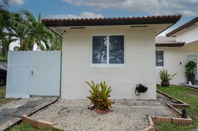 view of home's exterior featuring fence and stucco siding