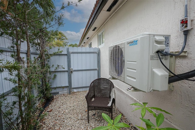 view of patio with ac unit and fence