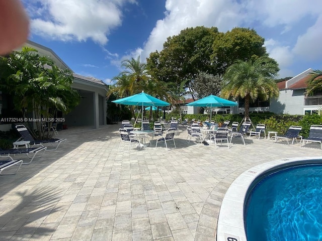 view of swimming pool featuring a patio area