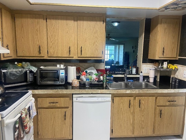 kitchen featuring ceiling fan, white appliances, and sink