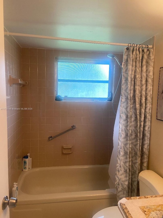 bathroom with toilet and shower / bath combo with shower curtain