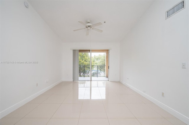 unfurnished room with ceiling fan, lofted ceiling, and light tile patterned floors