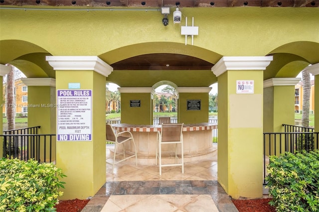 view of exterior entry with an outdoor bar