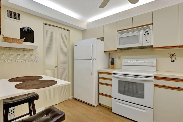 kitchen with white appliances, ceiling fan, and light wood-type flooring