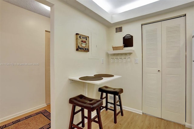 interior space with a textured ceiling and light wood-type flooring