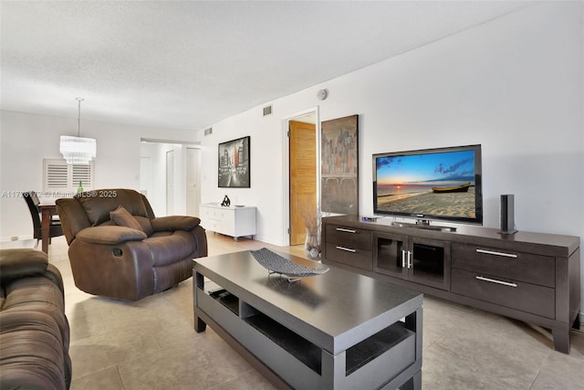 living room featuring a textured ceiling and a notable chandelier