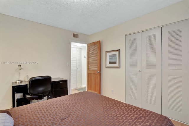 bedroom with a closet and a textured ceiling