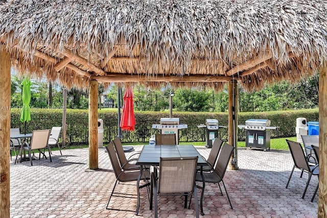 view of patio with area for grilling and a gazebo