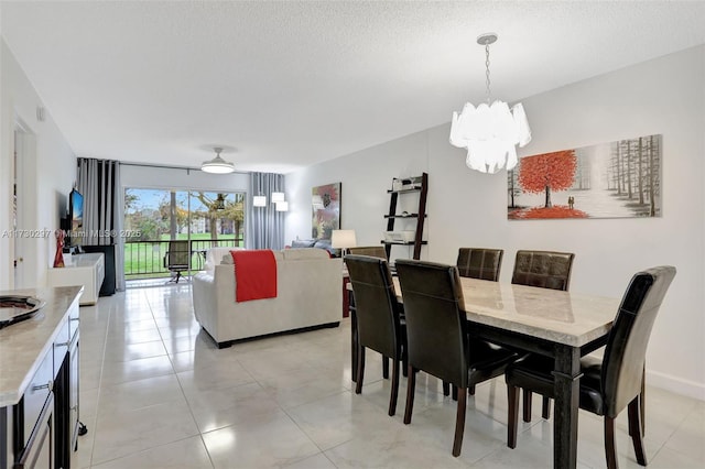 dining area featuring a notable chandelier and a textured ceiling