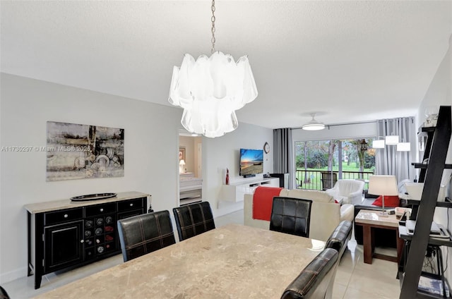 tiled dining area featuring a textured ceiling