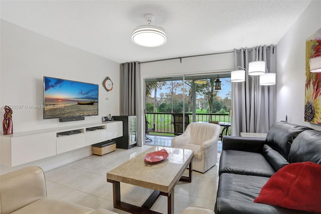 living room with a textured ceiling and light tile patterned flooring