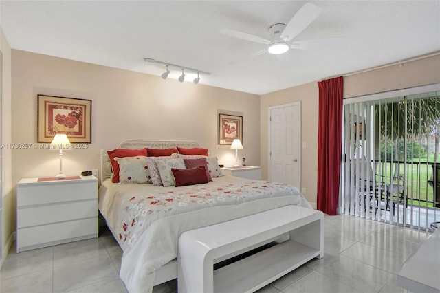 tiled bedroom featuring ceiling fan, rail lighting, a textured ceiling, and access to outside