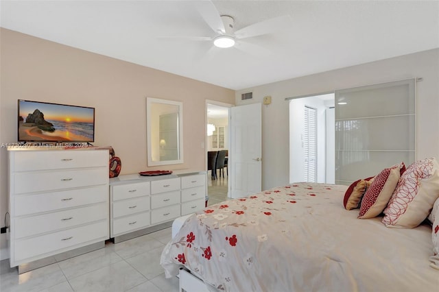 bedroom featuring light tile patterned flooring and ceiling fan