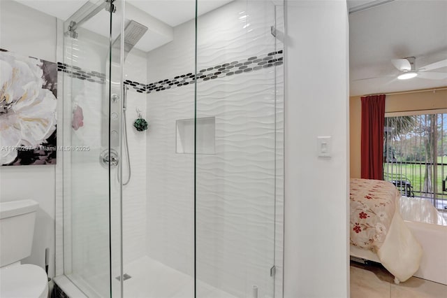 bathroom with an enclosed shower, ceiling fan, and toilet