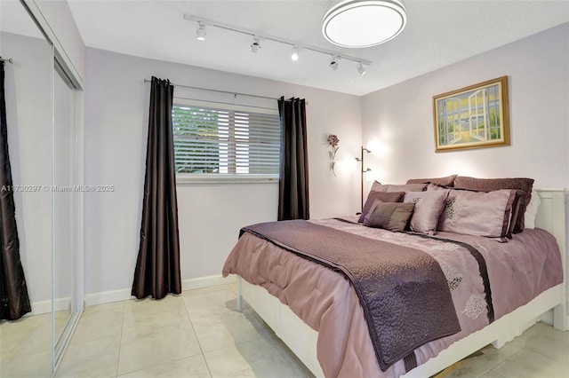 tiled bedroom with a closet