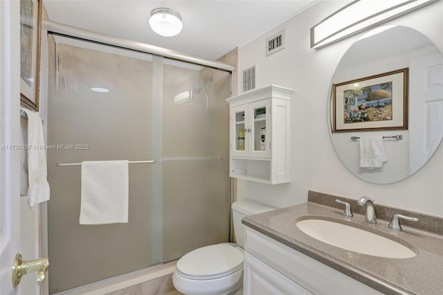 bathroom with vanity, toilet, and an enclosed shower