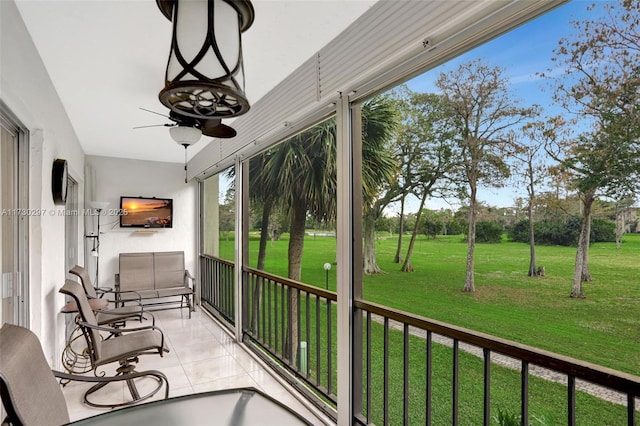 sunroom with a wealth of natural light and ceiling fan