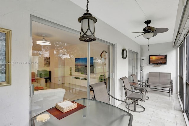 tiled dining space featuring ceiling fan