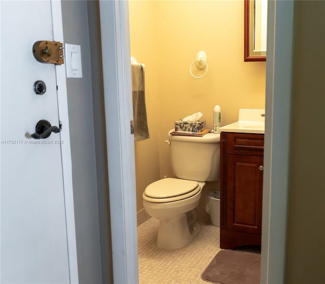 bathroom with vanity, toilet, and tile patterned flooring