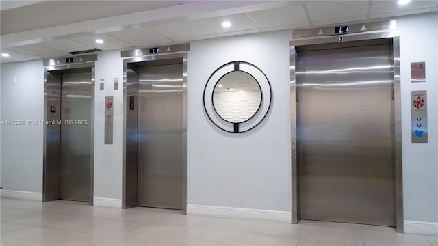 interior details featuring a drop ceiling and elevator