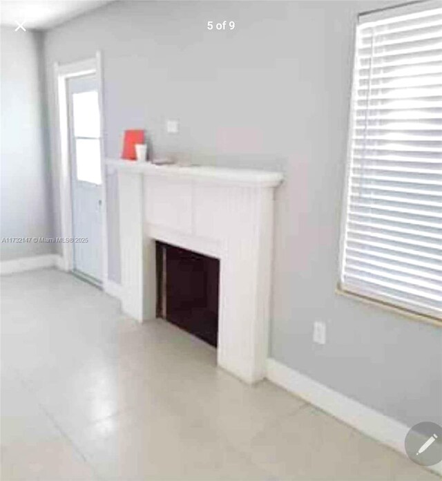 unfurnished living room featuring tile patterned flooring