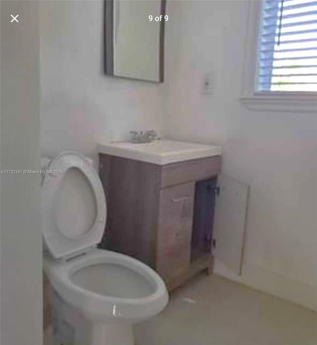 bathroom with toilet and vanity