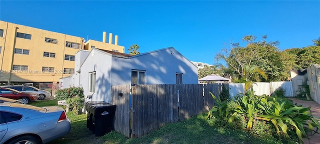 view of home's exterior featuring fence and stucco siding