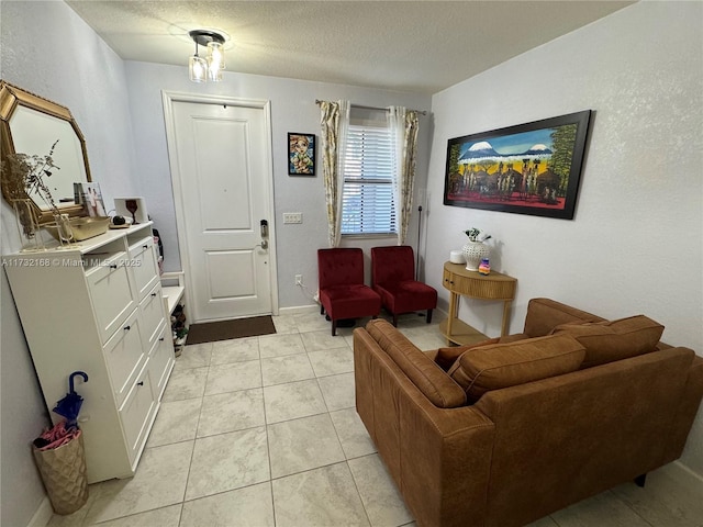 tiled living room featuring a textured ceiling