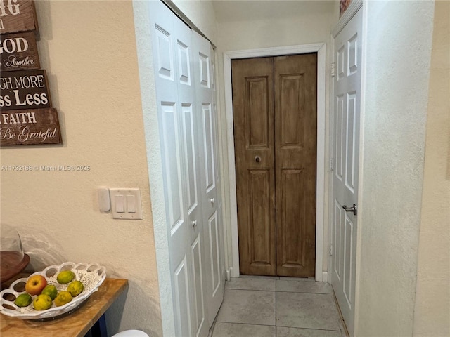 corridor featuring light tile patterned floors