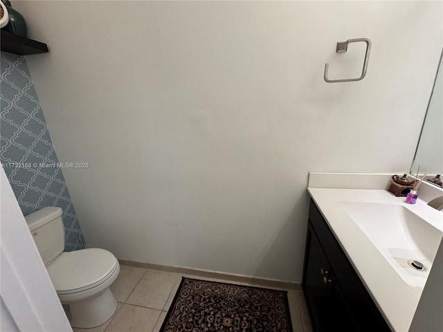 bathroom featuring vanity, tile patterned floors, and toilet