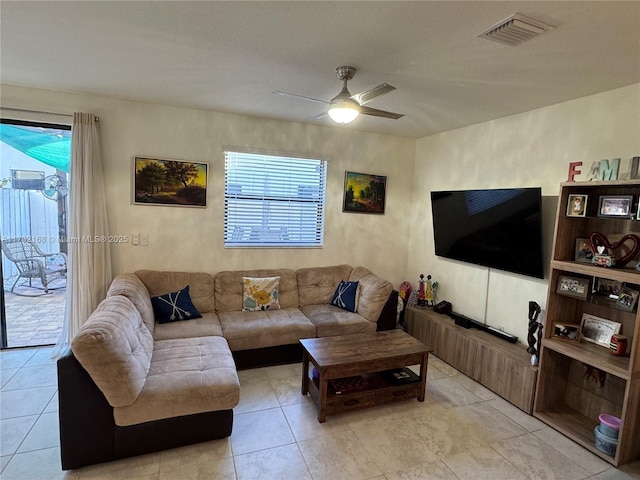 tiled living room with ceiling fan