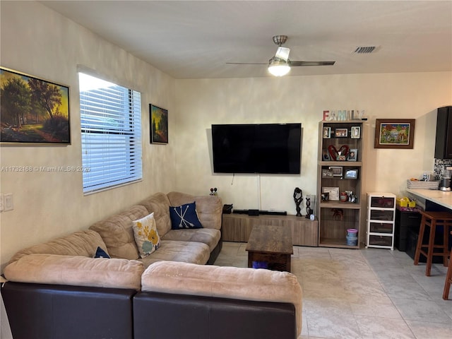 tiled living room with ceiling fan