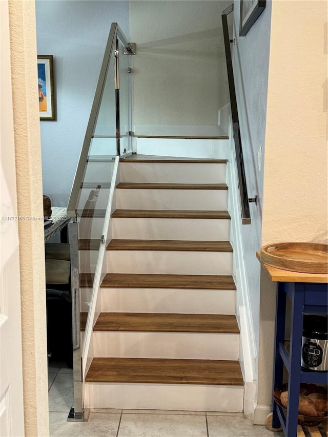 stairway featuring tile patterned floors